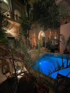 a swimming pool with plants in a building at Riad El Filali in Marrakesh