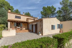 an exterior view of a house with a patio at Villa Mireia in Pollença