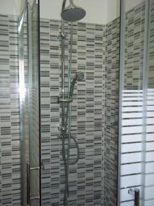 a shower with a shower head in a bathroom at Il Sole di Ostia in Lido di Ostia