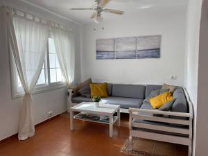 a living room with a couch and a table at Casa Peña en Son Bou in Son Bou