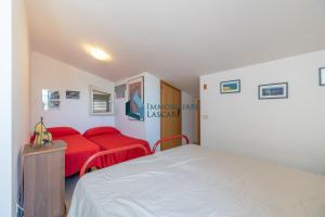 カンポフェリーチェ・ディ・ロッチェッラにあるVilla Limuti con piscina condominialeのベッドルーム1室(ベッド1台、赤いソファ付)