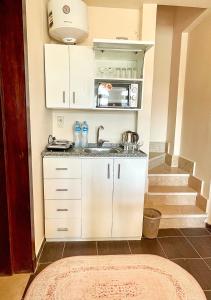 a small kitchen with a sink and a staircase at Fully Equipped Apartments Pool & Mountains View in Porto Sharm Resort in Sharm El Sheikh