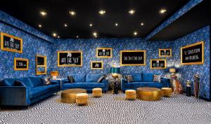 a living room with blue furniture and a blue wall at Hit the Sky in Sankt Christoph am Arlberg