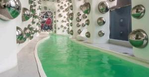 a swimming pool with green water in a building at Arte Plus AMPANG by Zzzayn in Batu Empat
