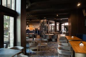 a restaurant with tables and chairs and a bar at Victoria Deluxe Hotel in Chernivtsi