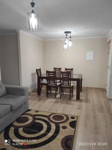 een woonkamer met een bank en een tafel en stoelen bij DEPARTAMENTO VILLARRICA 2 in Gorbea