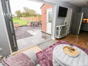 a living room with a couch and a table at 9 Pilgrims Way in Roch