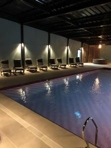 a large swimming pool with chairs and a poolificialificialificialificialificialificialificial at Hotel Boutique BC Wine Casablanca in Casablanca