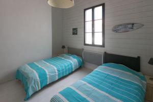 Posteľ alebo postele v izbe v ubytovaní Les Maisons de l'Olivette