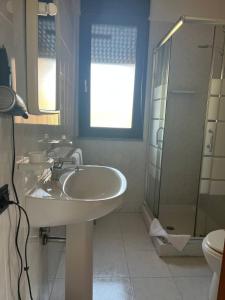 a bathroom with a sink and a shower and a toilet at Charme in Solèminis