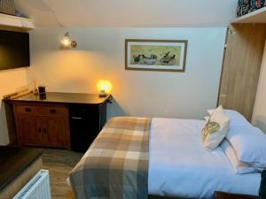 a hotel room with a bed and a desk at Whistley View in Brackley