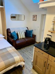 a room with a bed and a couch in it at Whistley View in Brackley