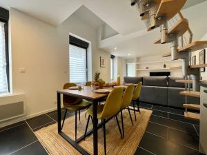 a dining room with a table and yellow chairs at Le logis BAYA - WEEKEND & HOLIDAY - WIFI & TV in Saint-Vigor-le-Grand