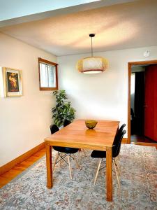 a dining room with a wooden table and chairs at Charming Home Away from Home in Thunder Bay