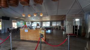 a large room with a counter and a woman sitting at a desk at Tropicana Beach & Resort in Elwa +133 photos