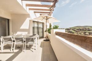 a dining table on the balcony of a house at Jardines - Acoran 3-2 PENTHOUSE NATURAL RESERVE VIEW & JACUZZI in Palm-mar
