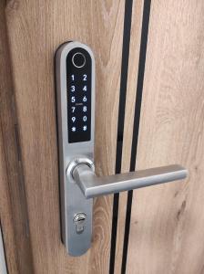 a close up of a door handle on a wooden door at Komfortowe przytulne nowoczesne mieszkanie Radom in Radom