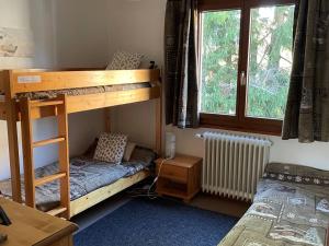 a bedroom with two bunk beds and a window at Appartement La Clusaz, 3 pièces, 6 personnes - FR-1-459-43 in La Clusaz