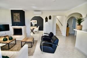 a living room with a couch and a table at Dream Villa in Benidoleig