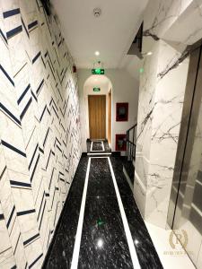 a hallway with black and white marble walls and a door at River View Hotel in Ho Chi Minh City