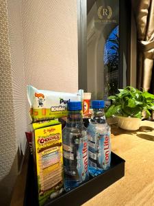 a shelf with two bottles of water and a bag of food at River View Hotel in Ho Chi Minh City