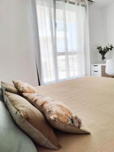 Łóżko lub łóżka w pokoju w obiekcie Allonbay Beach & Nature SPA Apartment