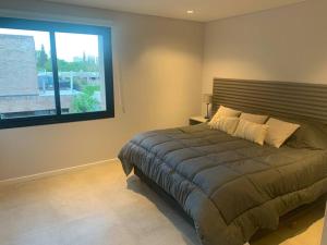 a bedroom with a large bed and a window at Duplex Lujan Mendoza cercanía Chacras de Coria in Ciudad Lujan de Cuyo