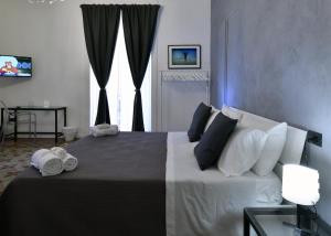 Postel nebo postele na pokoji v ubytování Frizzo House