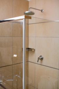 a shower with a glass door in a bathroom at Pahotela Bed and Breakfast in Palatswe