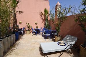 a patio with tables and chairs in a courtyard at Riad CK Medina in Marrakesh