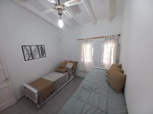 a bedroom with a bed and a ceiling fan at H125 - Complejo Mendoza in Mendoza