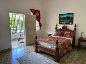 a bedroom with a bed in a room with a door at Hostal Cumbres del Volcan Flor Blanca in San Salvador