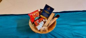 a basket filled with snacks on top of a bed at Parisa beach resort Tarkarli Bhogwe in Malvan