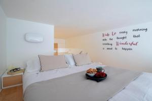 a bedroom with a bed with a bowl of fruit on it at Wanderlust by PortofinoHomes in Portofino