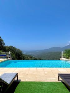a swimming pool with a view of the mountains at Villa U Tramontu in Granace