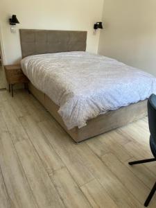 a bedroom with a bed and a wooden floor at Fisherman's Retreat in Wells next the Sea