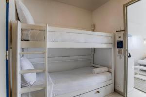 a bedroom with bunk beds and a mirror at Les Tamaris - Studio with Sea View - Trouville-Sur-Mer in Trouville-sur-Mer