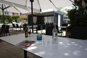 a white table with two bottles and glasses on it at City Partner Hotel Lenz in Fulda