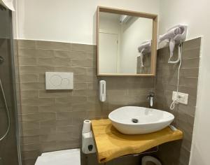 a bathroom with a sink and a mirror at Liotru Maisonne in Catania