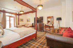 a bedroom with a bed and a living room at Gordonston Apartments in Inverness