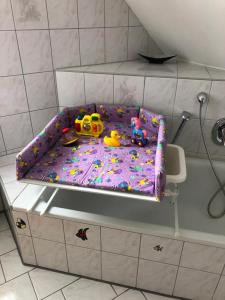a toy bed in a bathroom with toys on it at Konnis FerienHaus in Speichersdorf