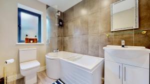 a bathroom with a toilet and a sink and a mirror at Chatham Serviced Apartments by Hosty Lets in Chatham