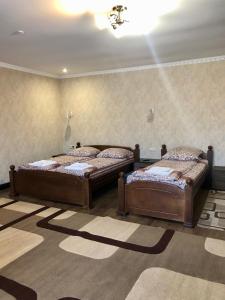 two beds sitting in a room with at Hotel Ashad in Svalyava