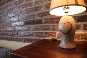 a heart shaped lamp sitting on a wooden table at A Janela do Alentejo in Campinho