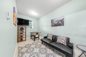 a living room with a couch and a flat screen tv at Alta Vista in Pacific City