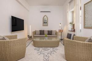 a living room with wicker chairs and a couch at Filigrana Villa Lindos in Lindos