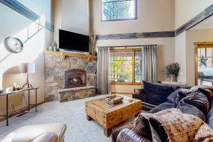 a living room with a couch and a fireplace at BOTHR Steelhead in McCall