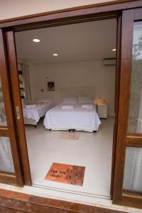 Кровать или кровати в номере Suites Amma Noronha