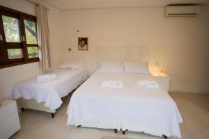 Кровать или кровати в номере Suites Amma Noronha