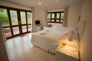 Кровать или кровати в номере Suites Amma Noronha